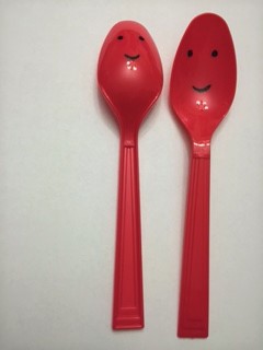 red, plastic party spoons with happy faces